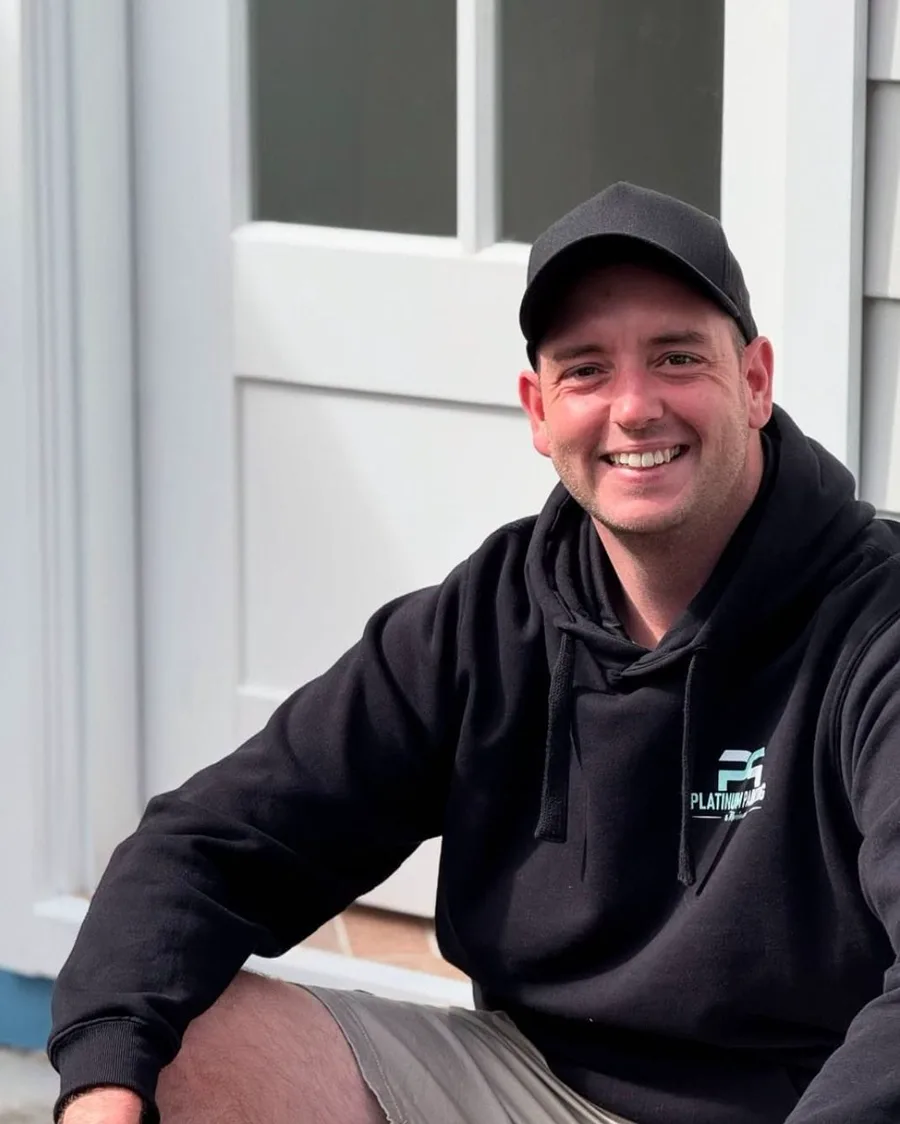 Dean, founder and lead painter of Platinum Painting, in his work hoodie