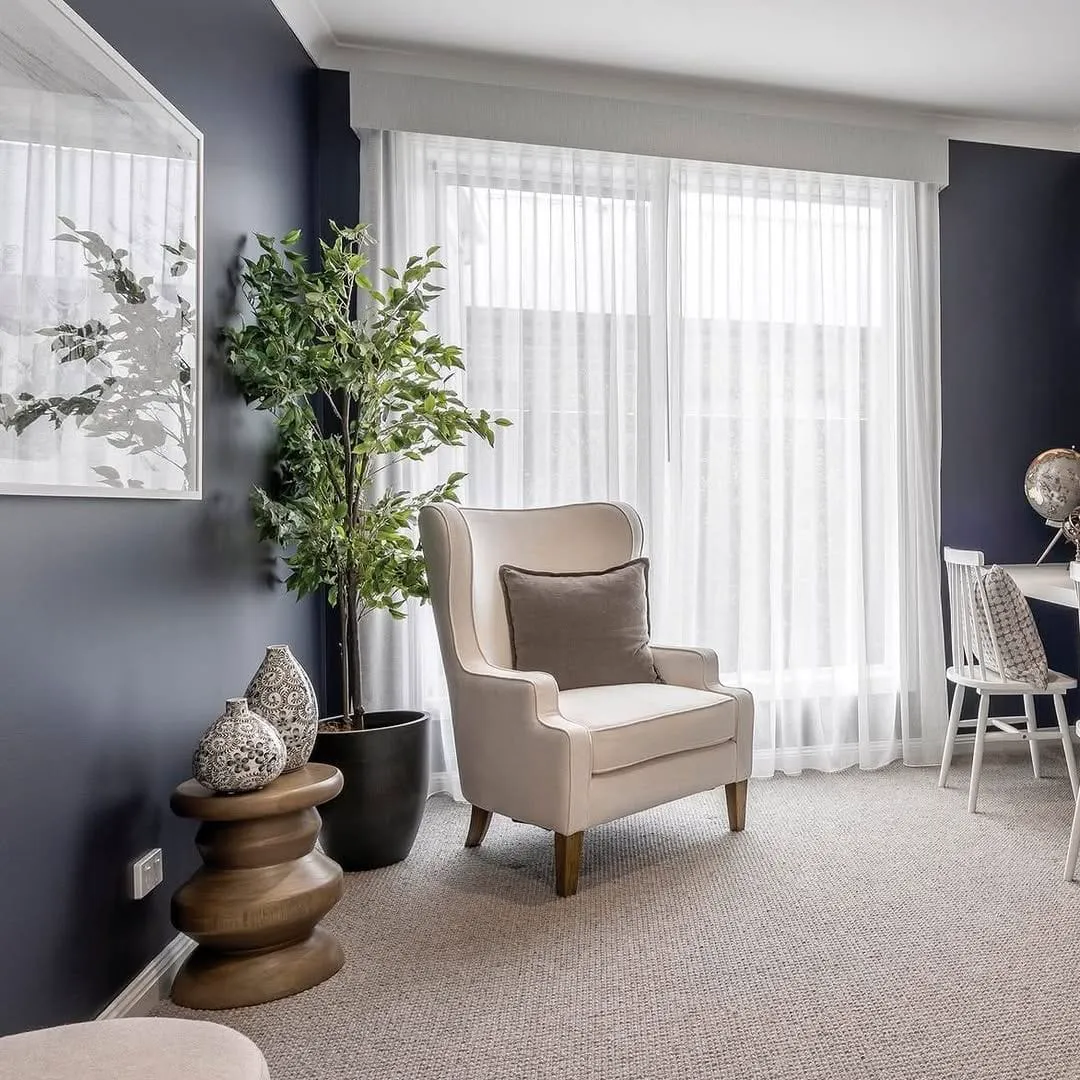 Sitting room corner with deep navy feature walls