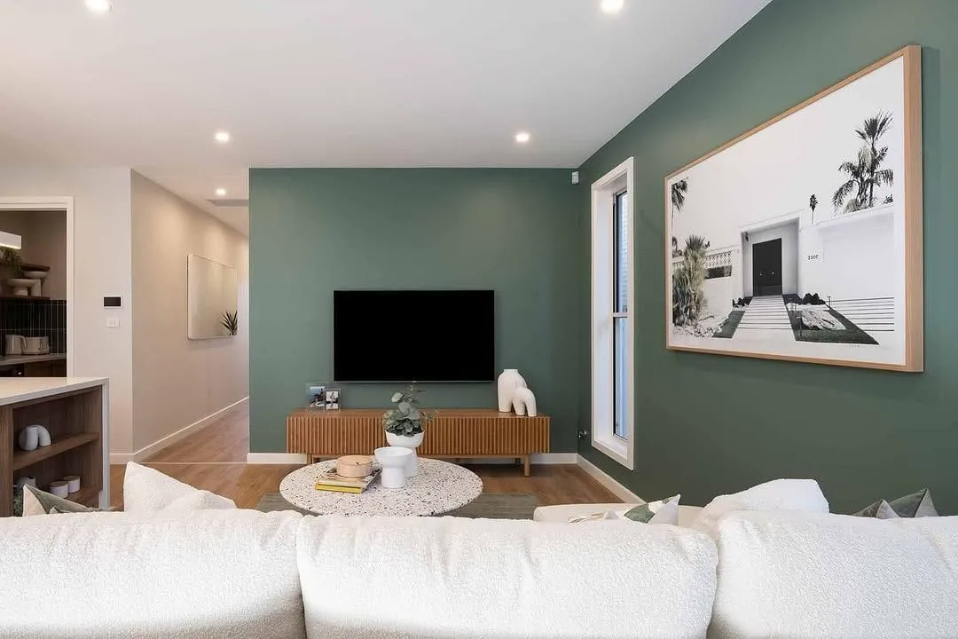 Living room with a sage green feature wall