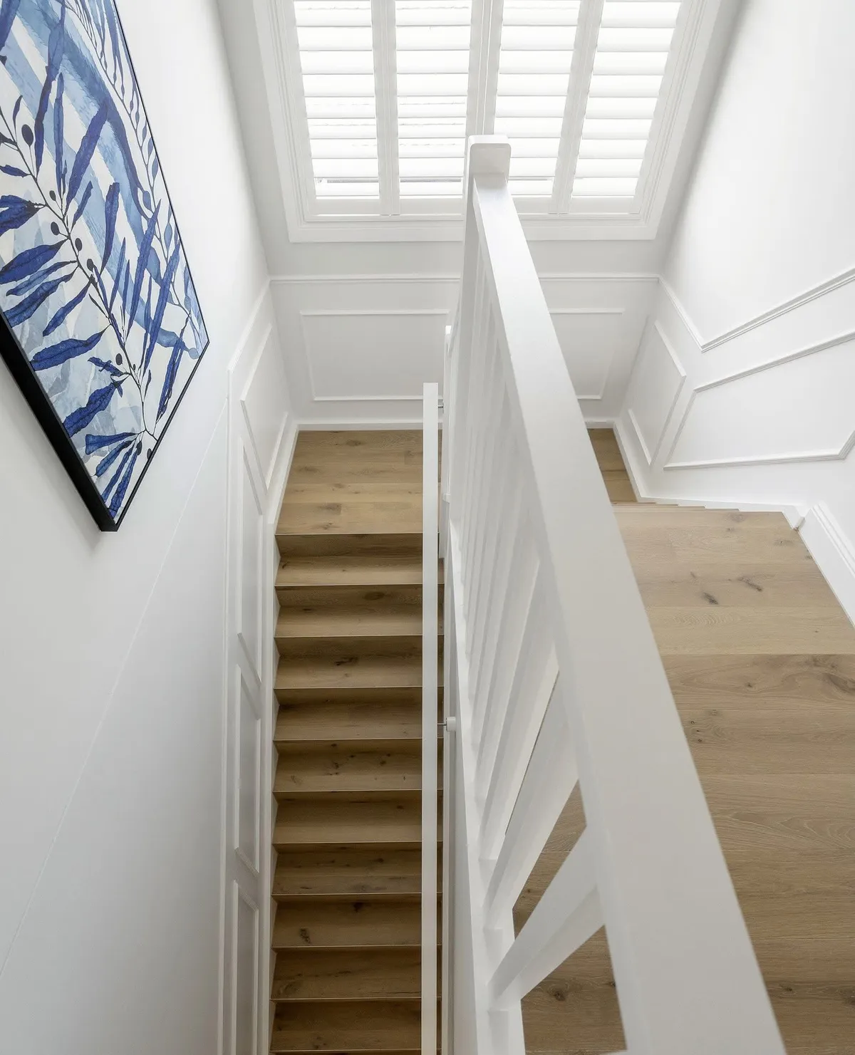 Stairwell with white panelling and blue feature artwork