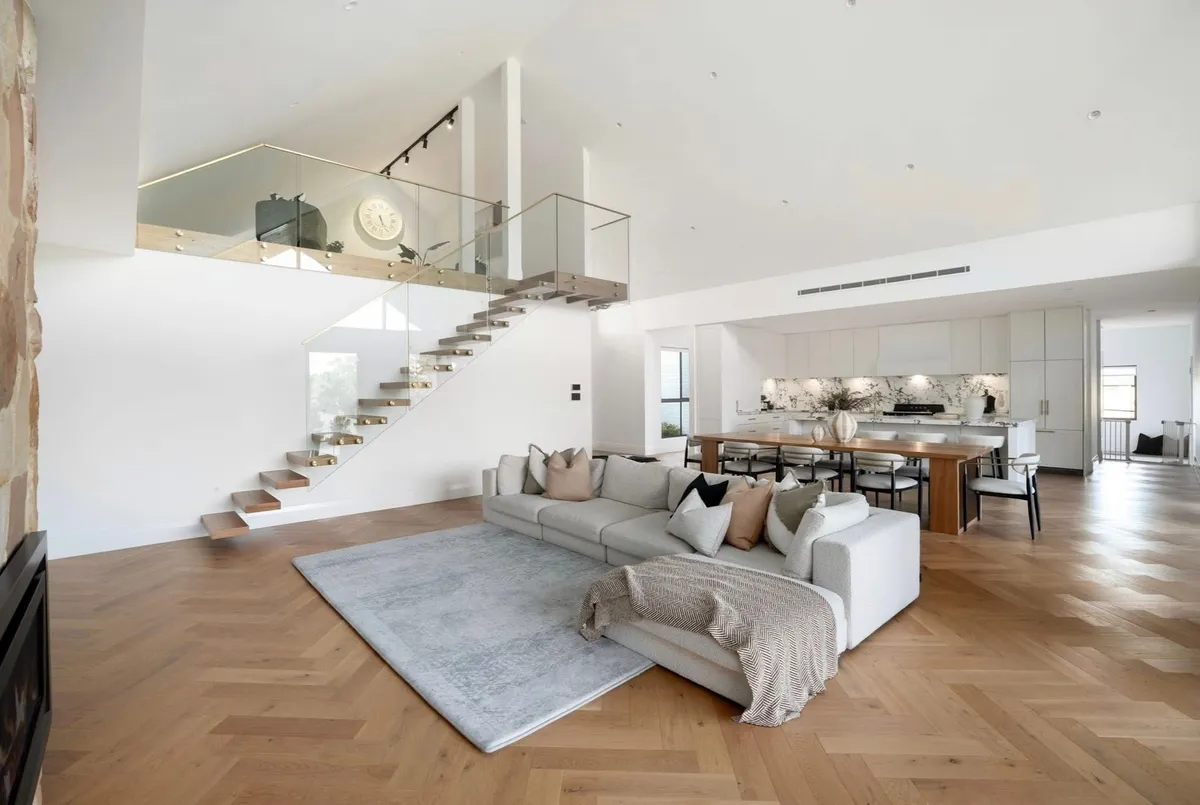 Double-height stair void and living space painted throughout