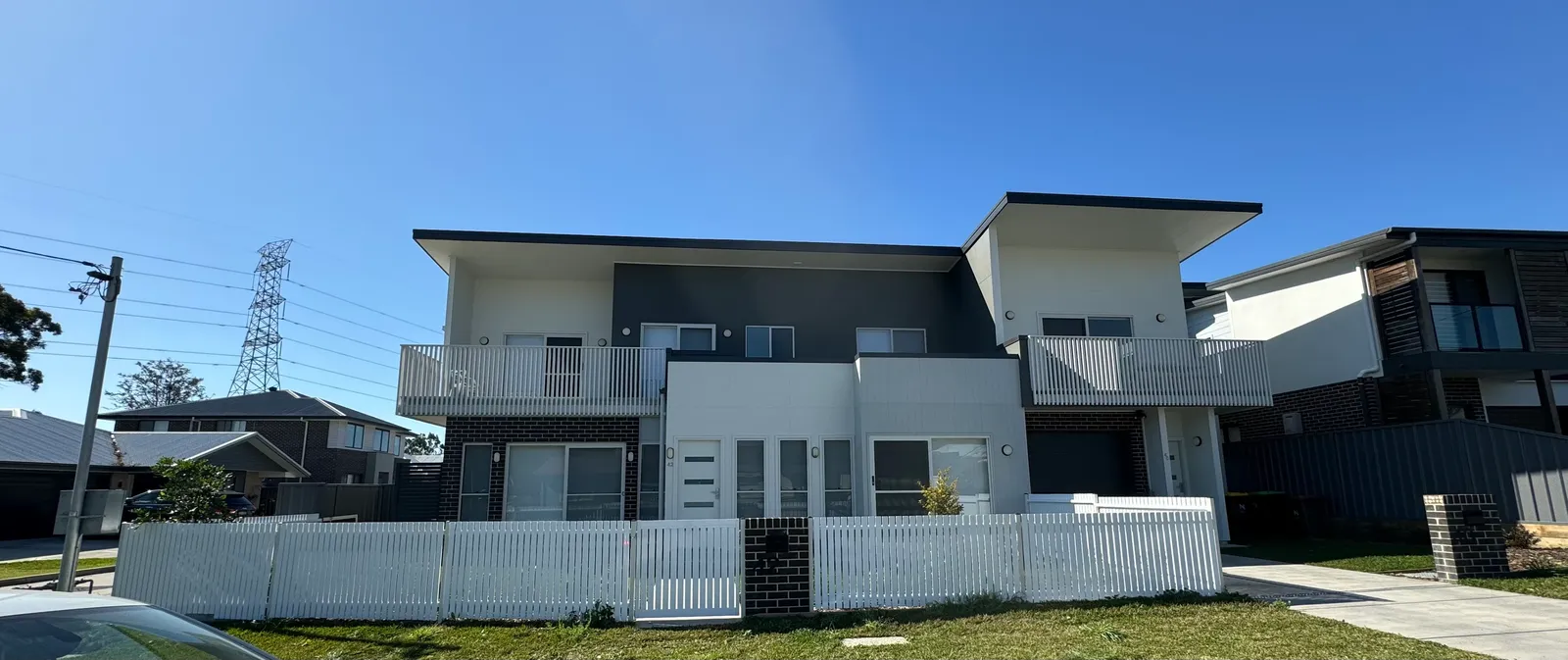 Modern strata duplex complex with crisp two-tone paintwork