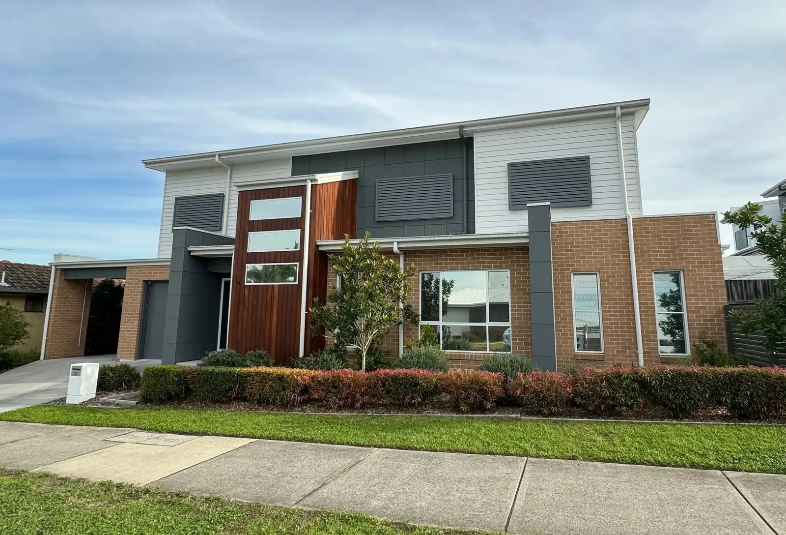 Two-storey brick and render duplex with fresh exterior paint